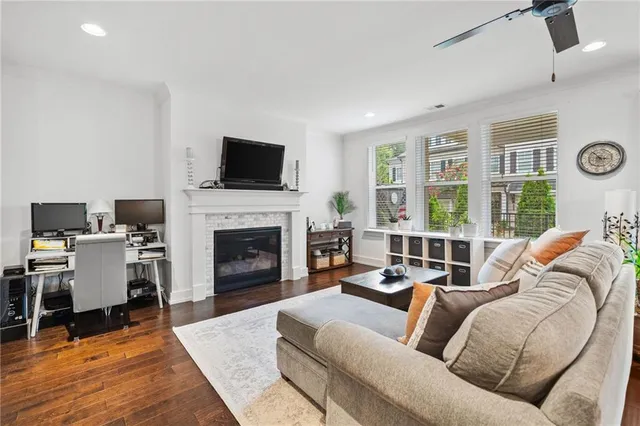 a living room with furniture a fireplace and a flat screen tv