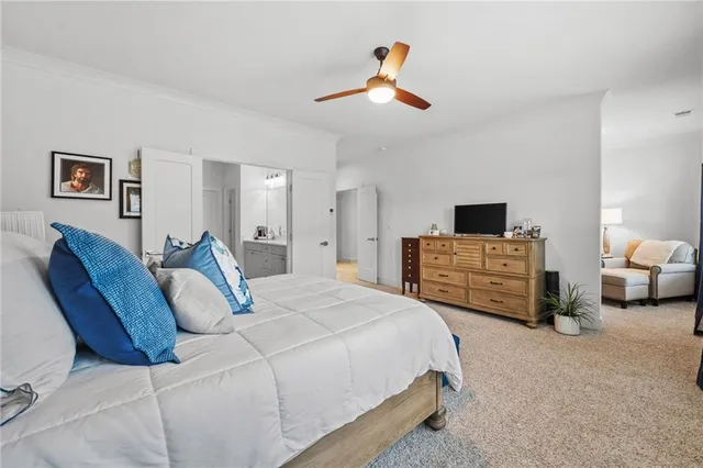 a spacious bedroom with a bed and a chandelier
