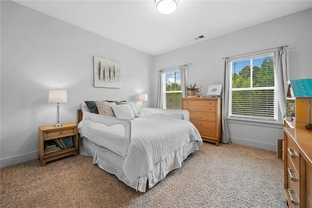 a spacious bedroom with a bed and a cabinets