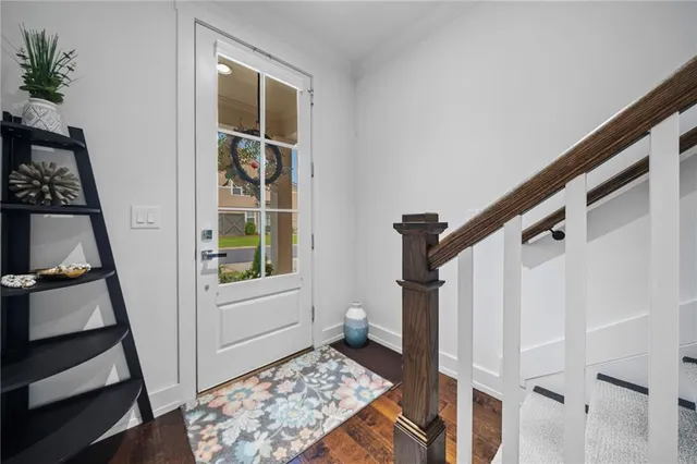 a view of an entryway with wooden floor and door