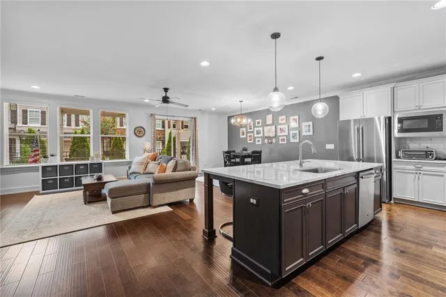 a kitchen with stainless steel appliances granite countertop a stove and a large refrigerator