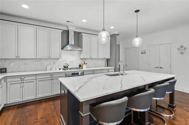 a kitchen with a table chairs sink and cabinets