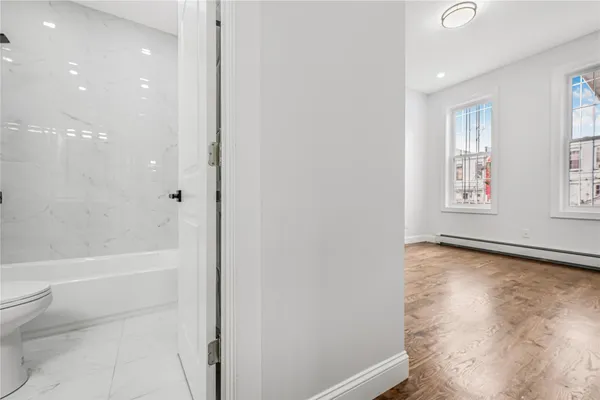 a bathroom with a bathtub and a toilet