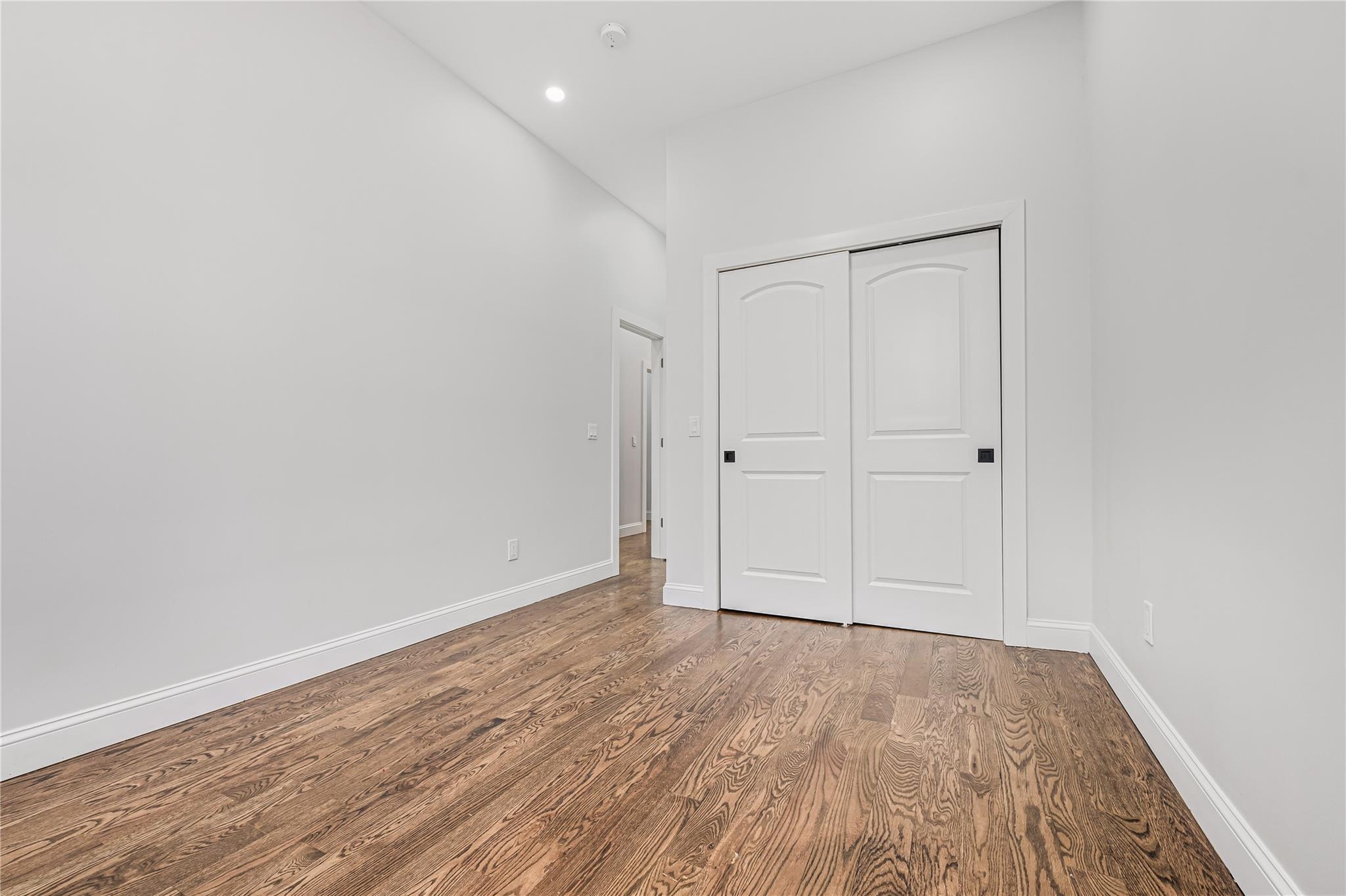 164 Atkins Avenue, Unit 2 Brooklyn, NY 11208 - Photo 3 of 23 a view of an empty room with wooden floor