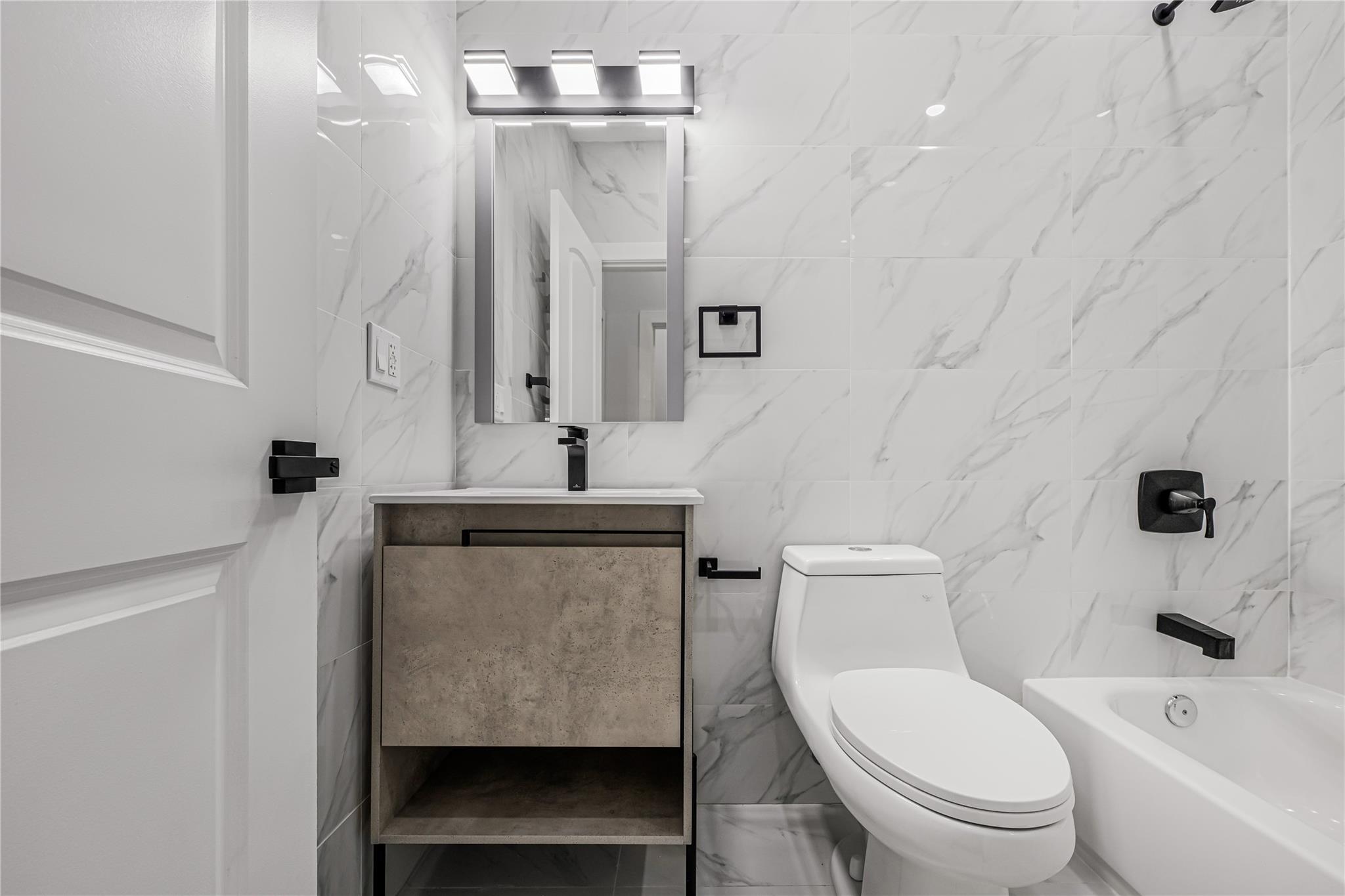 164 Atkins Avenue, Unit 2 Brooklyn, NY 11208 - Photo 7 of 23 a bathroom with a sink a toilet and shower