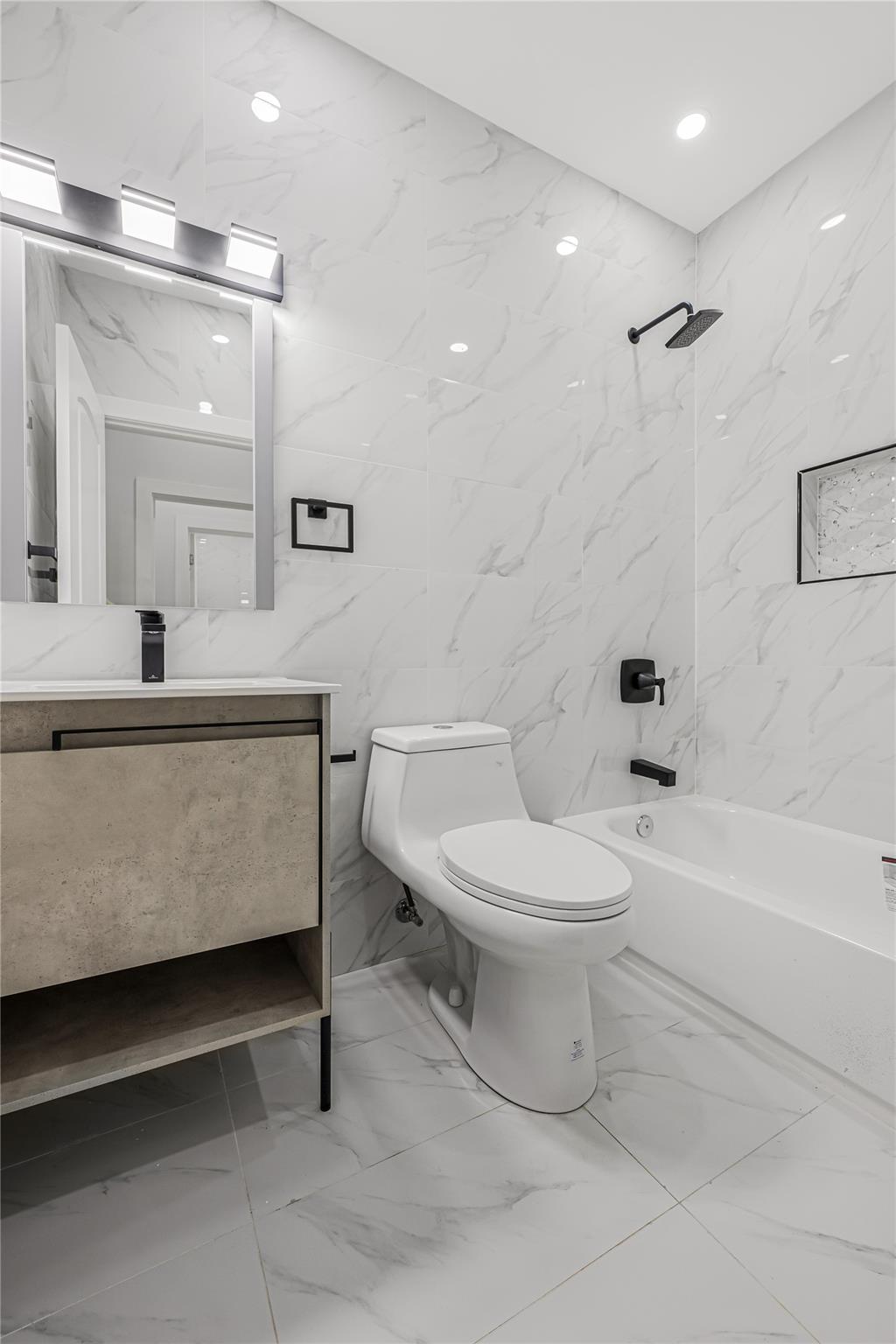 164 Atkins Avenue, Unit 2 Brooklyn, NY 11208 - Photo 8 of 23 a bathroom with a toilet a sink and a bathtub