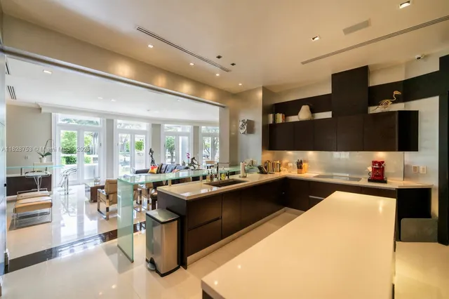 a kitchen with stainless steel appliances granite countertop a sink and a refrigerator