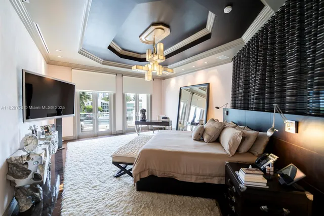 a bedroom with a bed a mirror and dresser