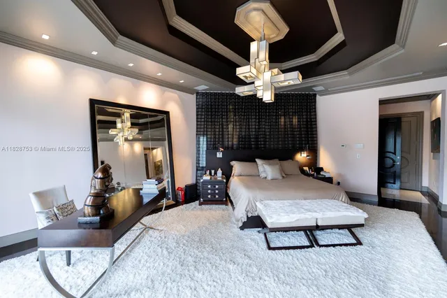 a living room with furniture a bookshelf and a large window