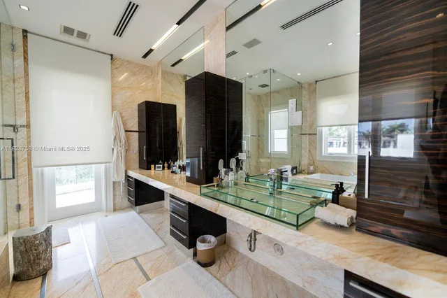 a bathroom with a sink mirror and a toilet
