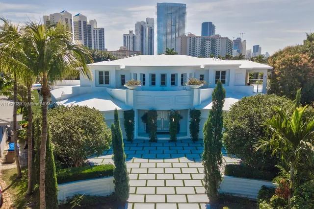 a front view of a building with a garden