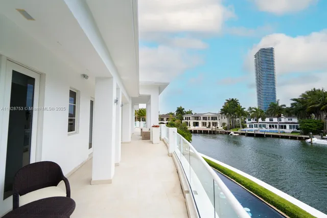 a view of a balcony with chairs and chandelier