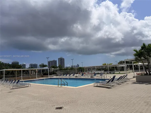 a view of a swimming pool with outdoor seating