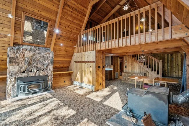a view of a patio with table and chairs with wooden floor and fence