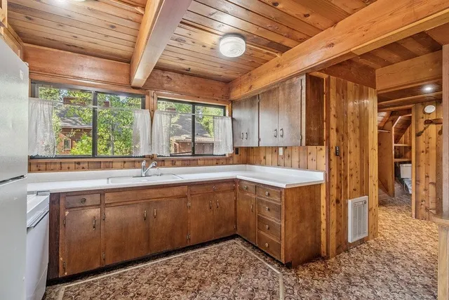 a kitchen with a sink and wooden cabinets