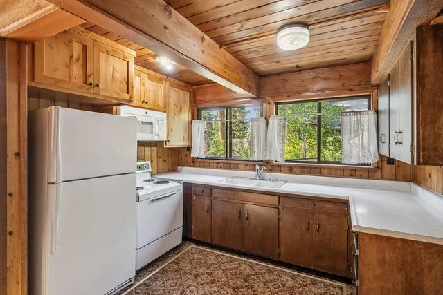 a white refrigerator freezer sitting inside of a kitchen