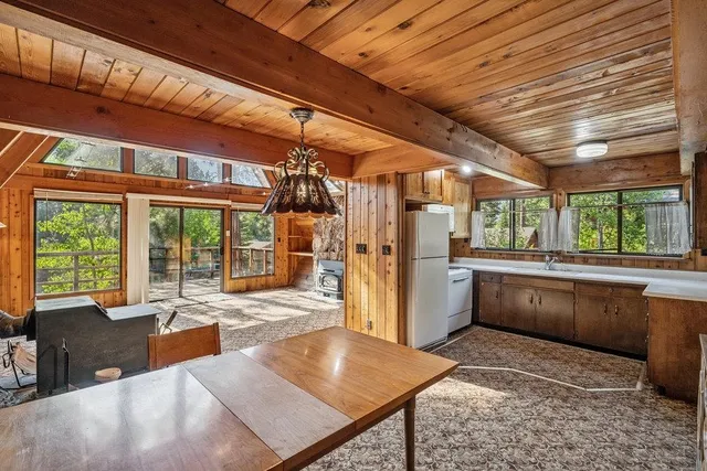 a large kitchen with a large window and furniture