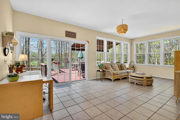 a living room with furniture and large windows