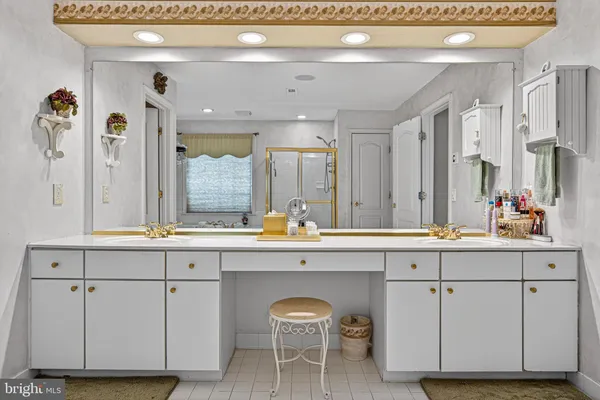 a spacious bathroom with a granite countertop double sink and a mirror