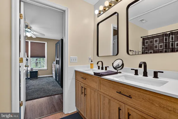 a en suite bathroom with a sink a mirror and shower