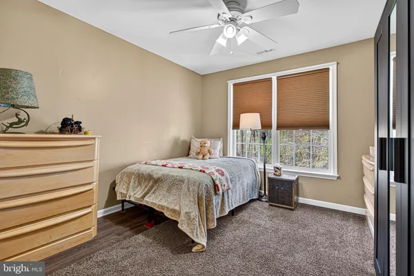 a spacious bedroom with a bed and a window