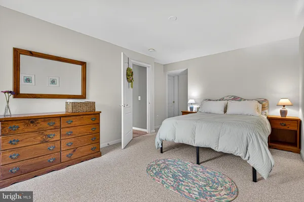 a bedroom with a bed and a dresser
