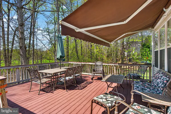 a view of a chairs and table on the deck