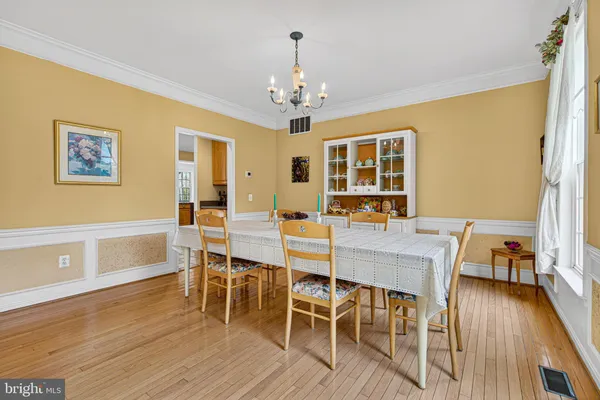 a view of a dining room with furniture wooden floor and chandelier
