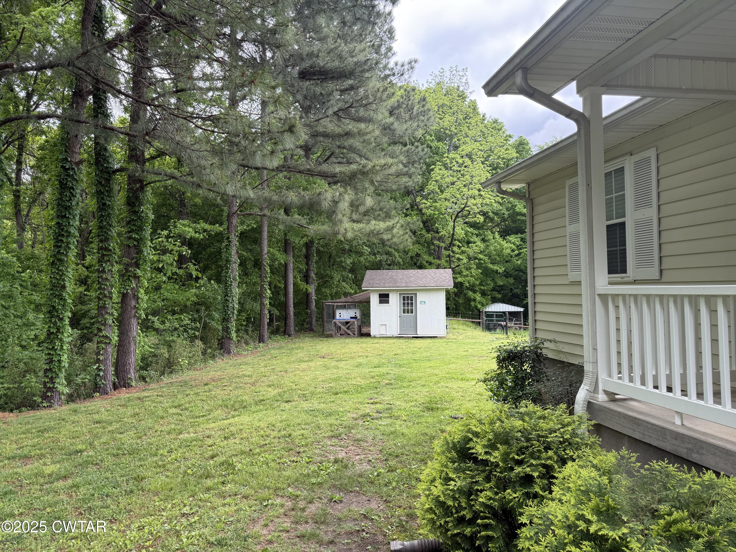0 Webb Store Road Hornbeak, TN 38232 - Photo 18 of 22 a house with trees in front of it