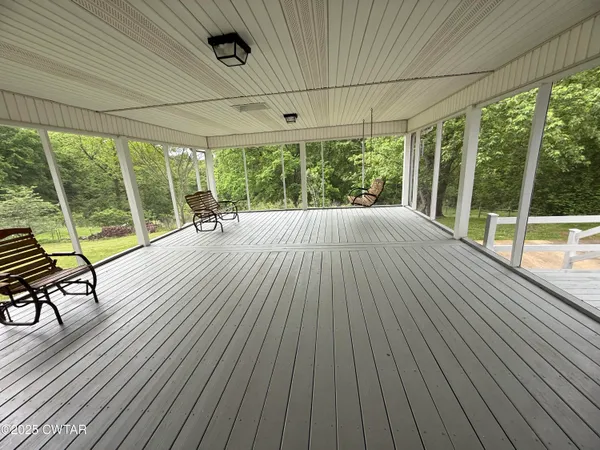 a view of porch with wooden floor