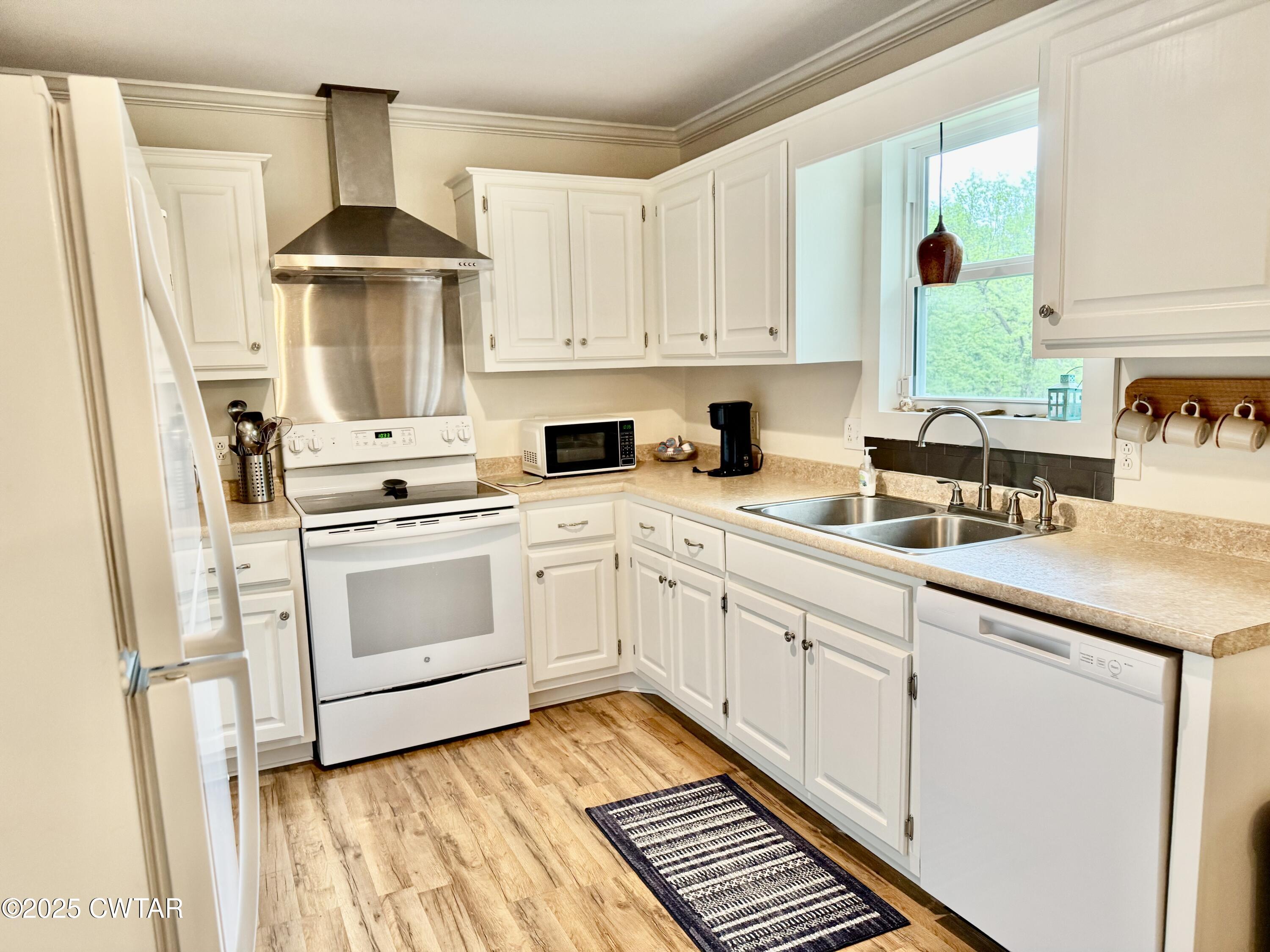 0 Webb Store Road Hornbeak, TN 38232 - Photo 6 of 22 a kitchen with white cabinets and white appliances
