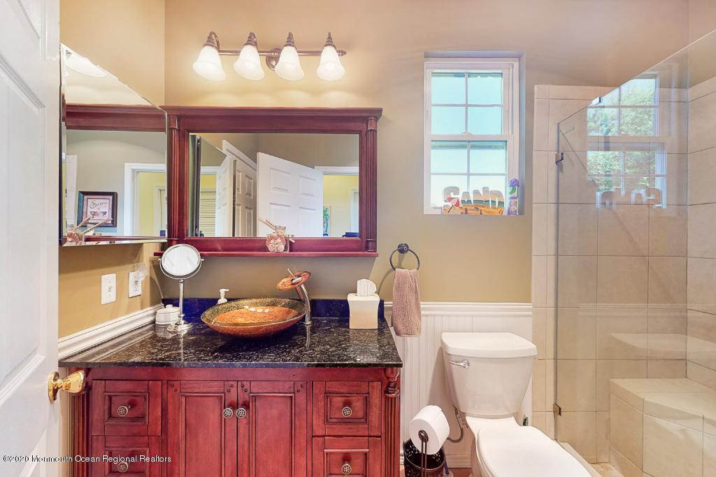 43 Portland Road Highlands, NJ 07732 - Photo 21 of 47 a bathroom with a granite countertop toilet sink and mirror