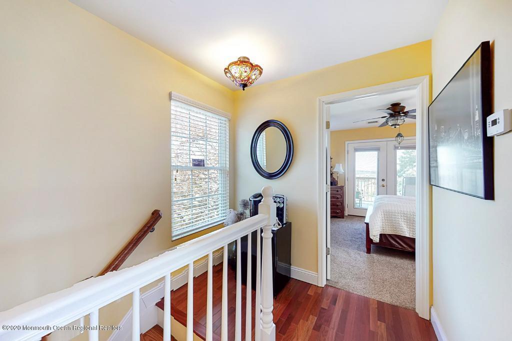 43 Portland Road Highlands, NJ 07732 - Photo 22 of 47 a view of a hallway with wooden floor and a bathroom