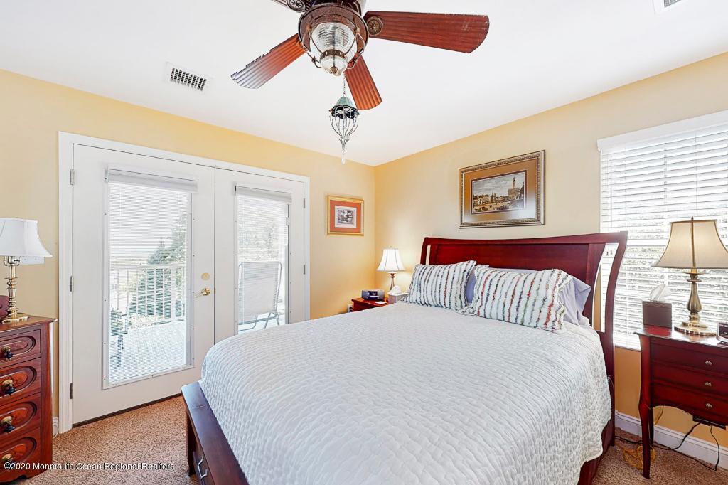 43 Portland Road Highlands, NJ 07732 - Photo 23 of 47 a bedroom with a large bed and a chandelier
