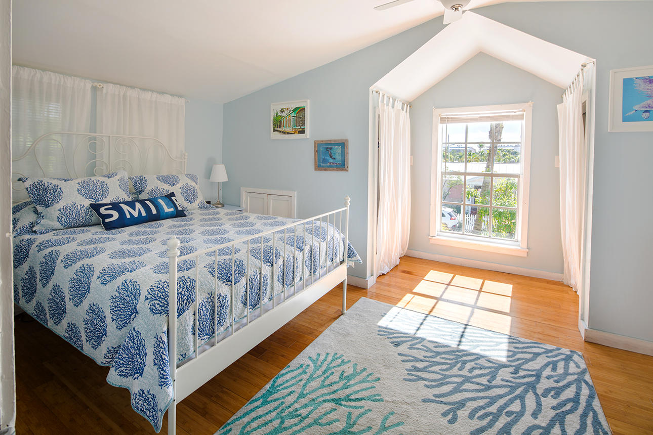 1425 Laird Street Key West, FL 33040 - Photo 19 of 26 a bedroom with a bed a window and walk in closet
