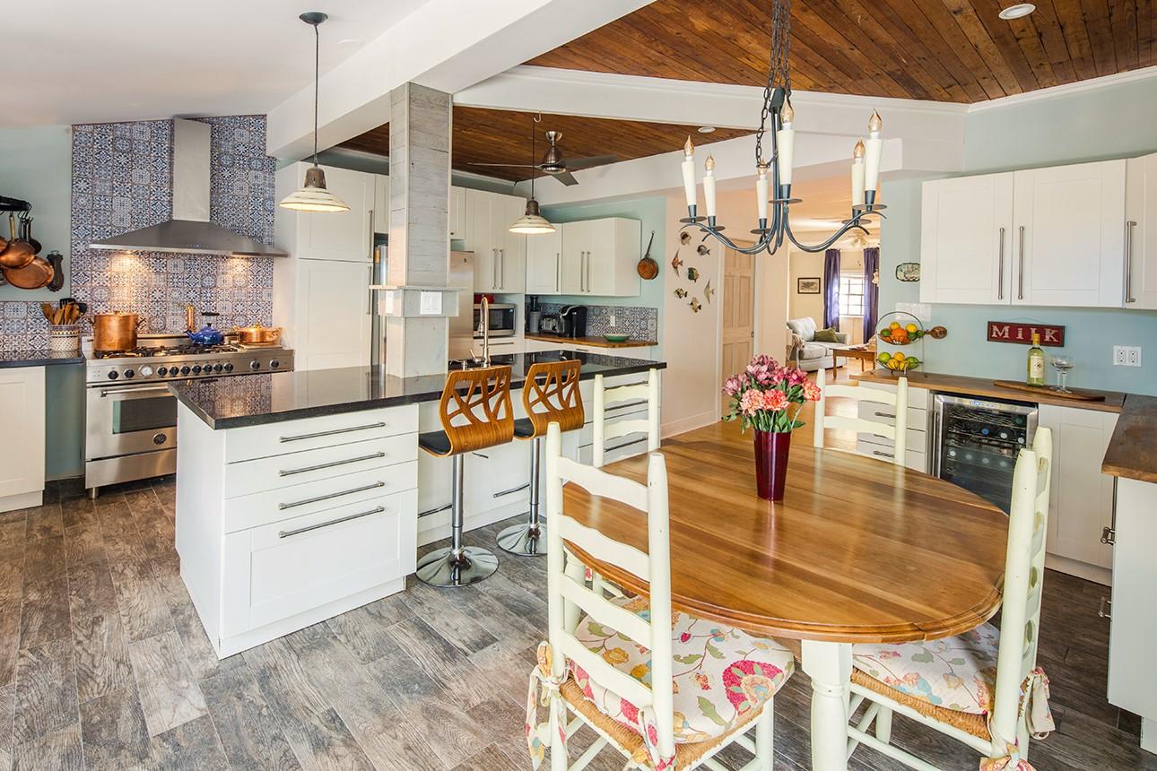 1425 Laird Street Key West, FL 33040 - Photo 5 of 26 a kitchen with stainless steel appliances kitchen island granite countertop a table and chairs in it