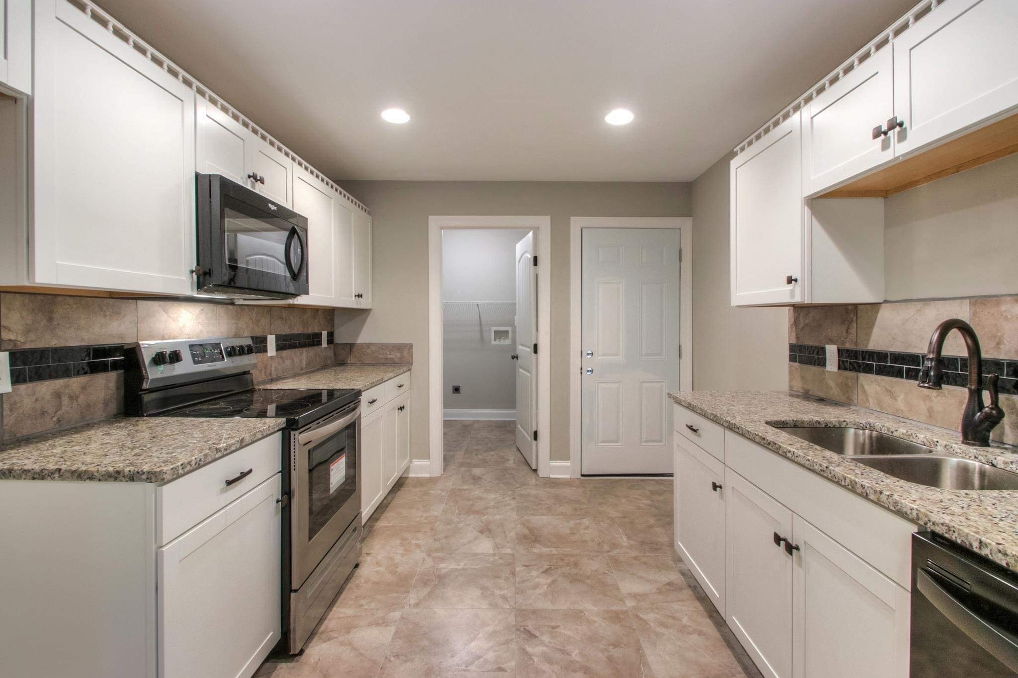 321 South Leath Road Portland, TN 37148 - Photo 14 of 33 a large kitchen with stainless steel appliances granite countertop a sink stove and refrigerator