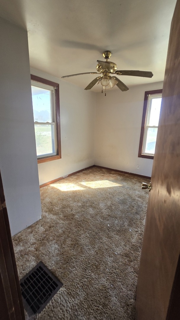 4710 Section Street Streator, IL 61364 - Photo 13 of 19 an empty room with windows and fan