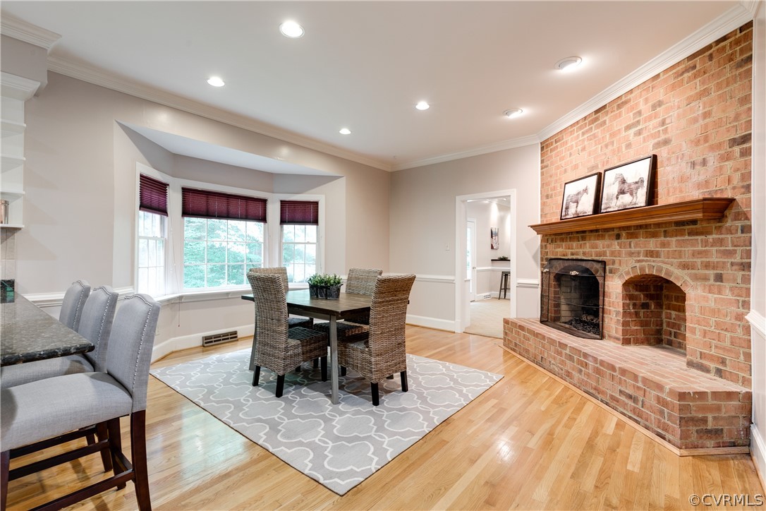 3830 Reeds Landing Circle Midlothian, VA 23113 - Photo 14 of 50 a living room with furniture a fireplace and a dining table with kitchen view