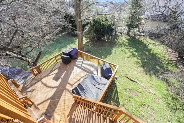 a view of balcony with wooden floor and outdoor seating