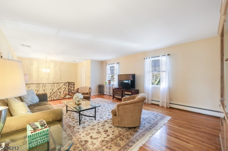 68 Colgate Avenue Paramus, NJ 07652 - Photo 3 of 14 a living room with furniture a wooden floor and a potted plant