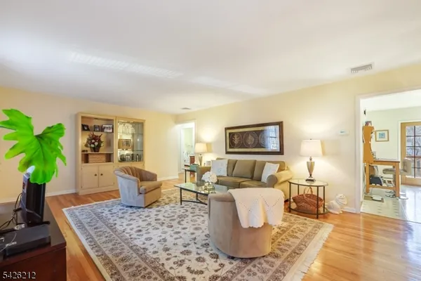a living room with furniture potted plant and a table