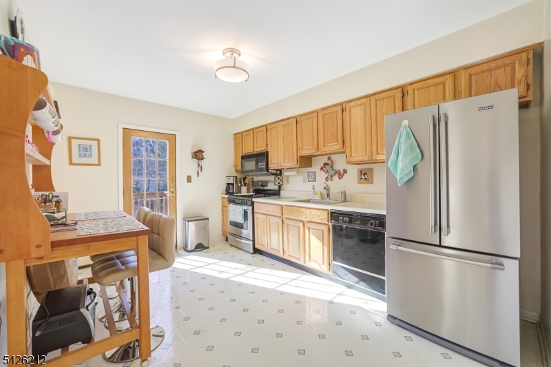 68 Colgate Avenue Paramus, NJ 07652 - Photo 6 of 14 a kitchen with stainless steel appliances a refrigerator sink and cabinets