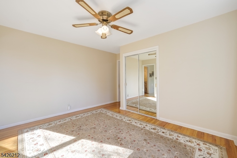 68 Colgate Avenue Paramus, NJ 07652 - Photo 9 of 14 an empty room with a window and a ceiling fan