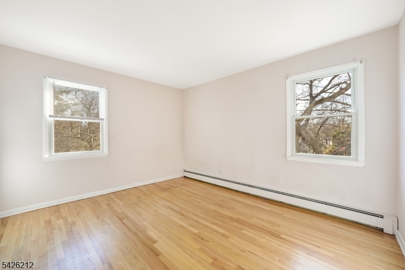 68 Colgate Avenue Paramus, NJ 07652 - Photo 10 of 14 a view of an empty room with wooden floor and a window