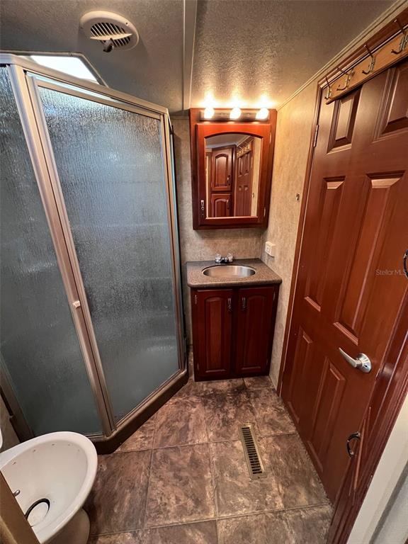 3000 Clarcona Road, Unit 343 Apopka, FL 32703 - Photo 4 of 15 a bathroom with a sink a toilet a mirror and vanity