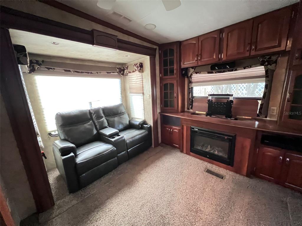 3000 Clarcona Road, Unit 343 Apopka, FL 32703 - Photo 6 of 15 a living room with furniture and a fireplace