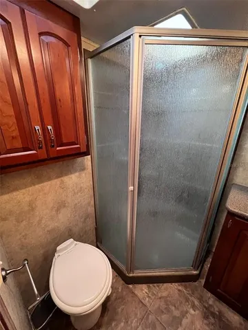 a bathroom with a toilet and a shower