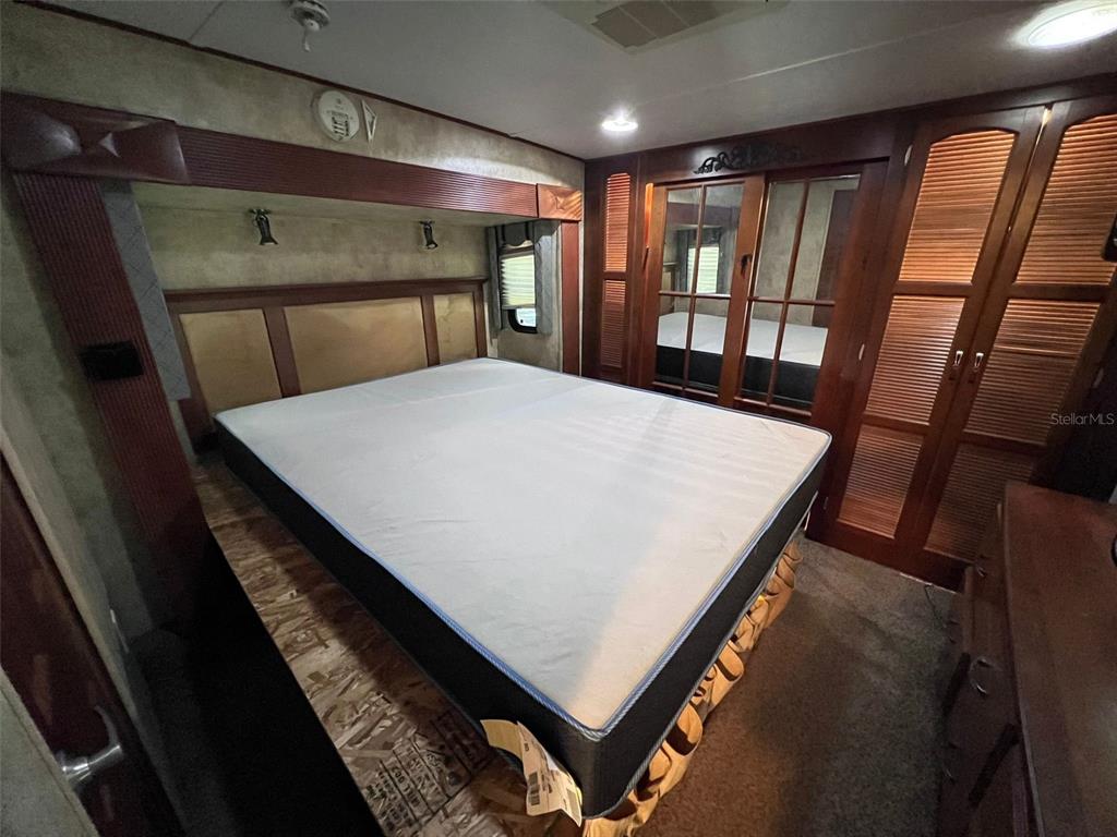 3000 Clarcona Road, Unit 343 Apopka, FL 32703 - Photo 9 of 15 a bed sitting in a bedroom next to a window