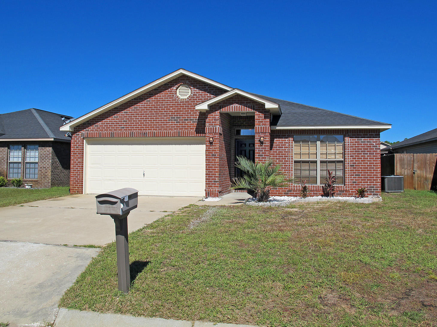 7980 Promise Creek Road Navarre, FL 32566 - Photo 1 of 31 a front view of a house with garden